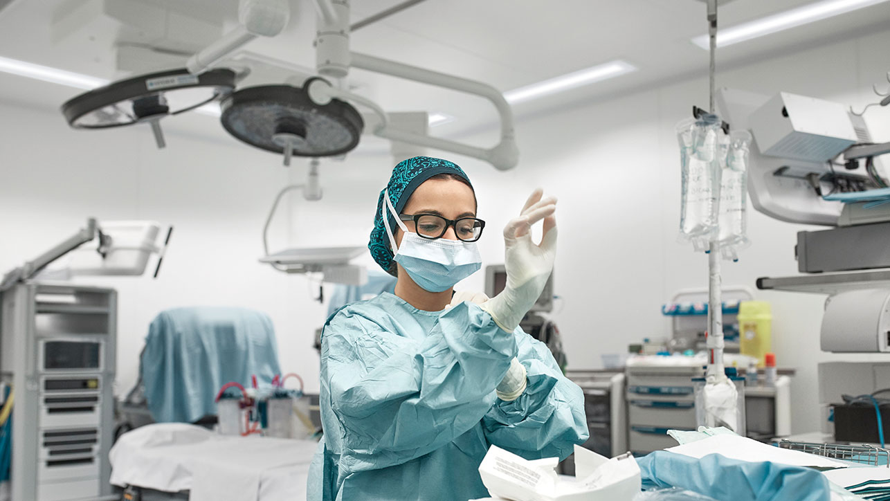 Surgeon preparing in operating room lit by HSTL from Nightingale